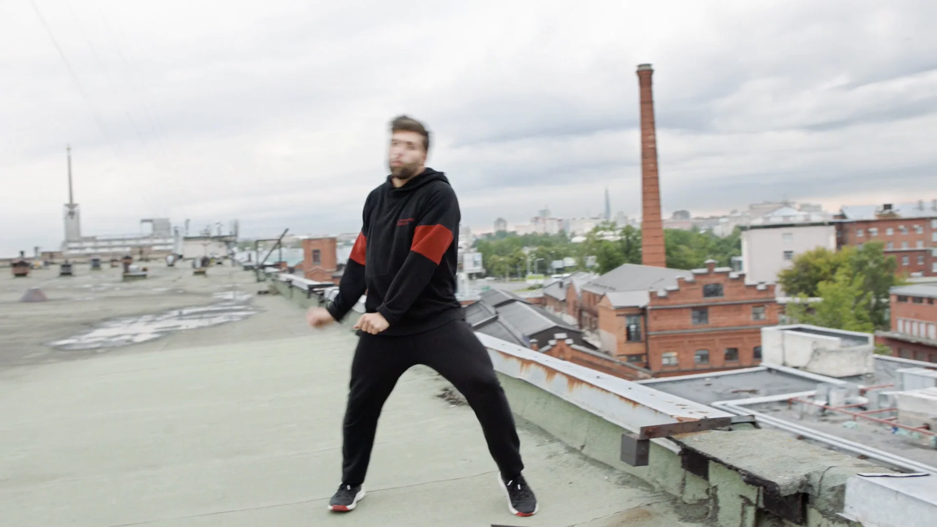 The same frame brightened, with lighter sky, clearer rooftop and more detail in the dancer