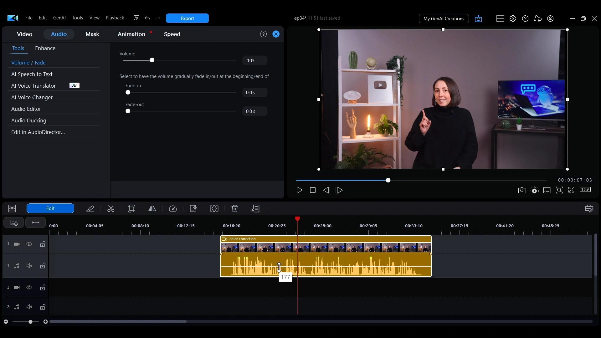The white volume line on an audio clip in the PowerDirector timeline being dragged with the mouse.