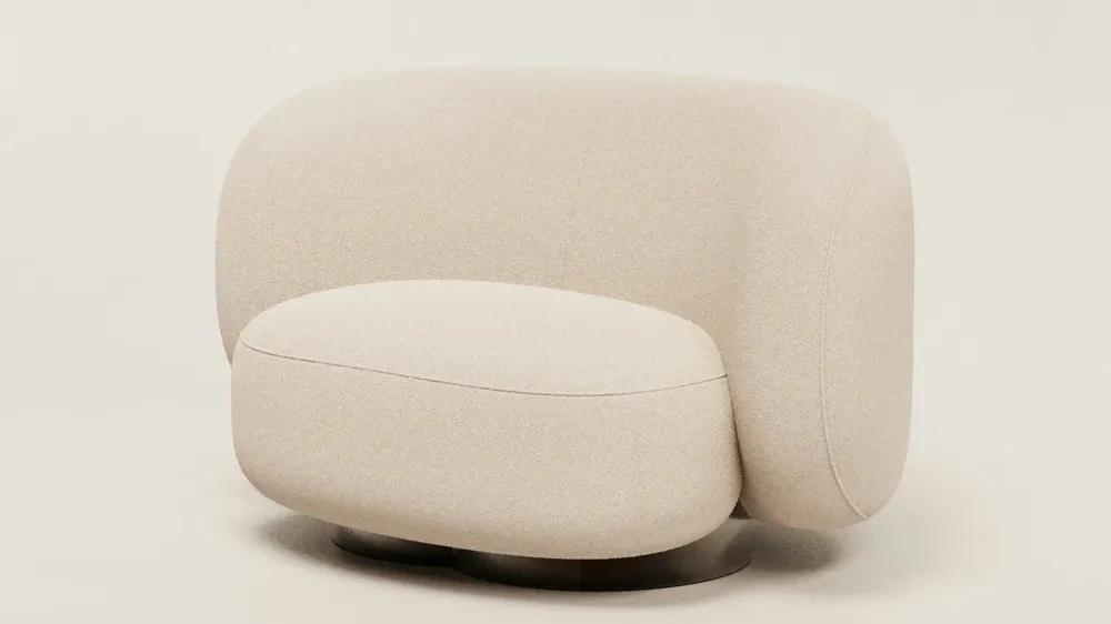 Plain studio photo of a cream boucle armchair on a pale background
