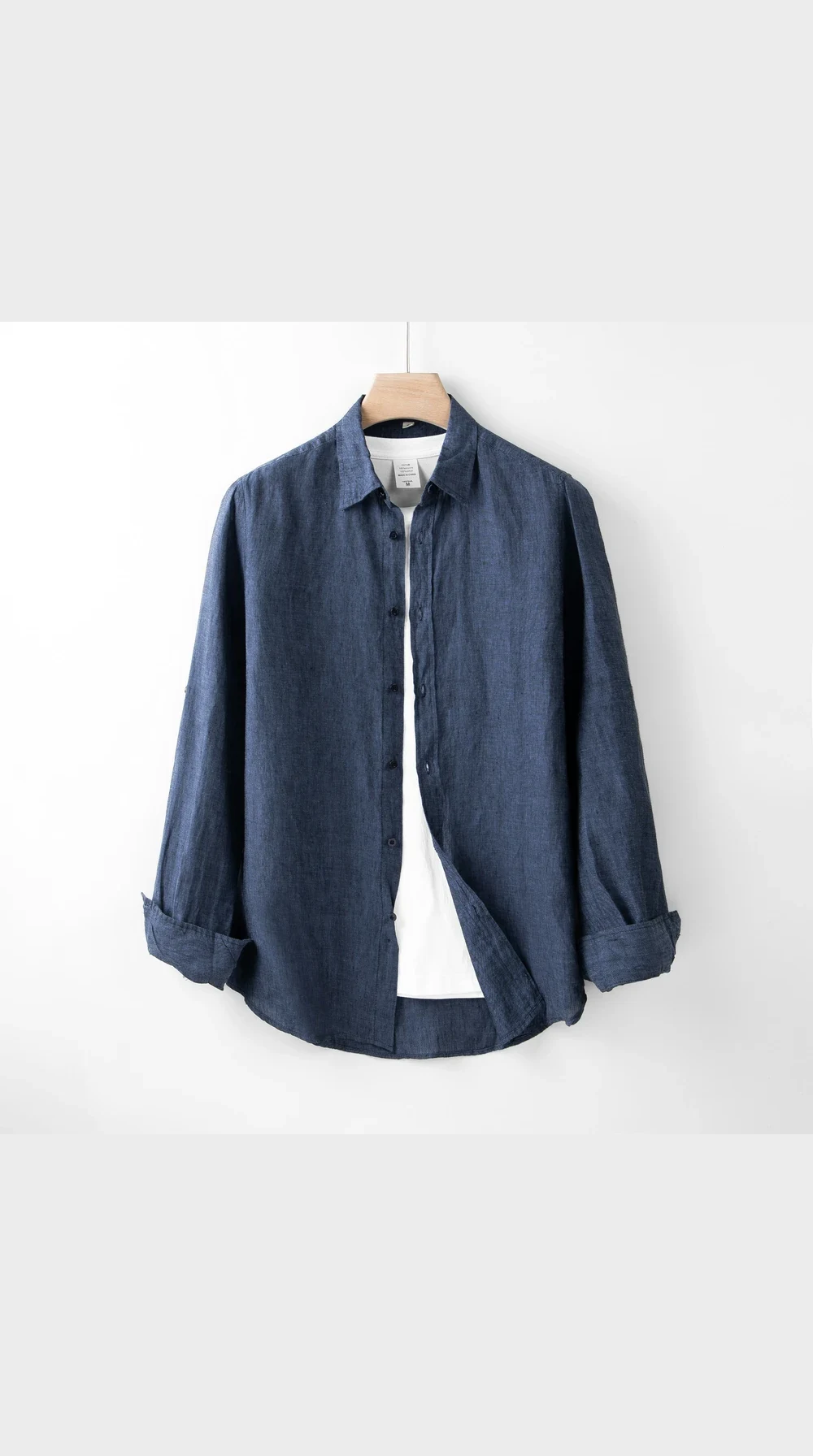 A denim shirt photographed flat against a plain background