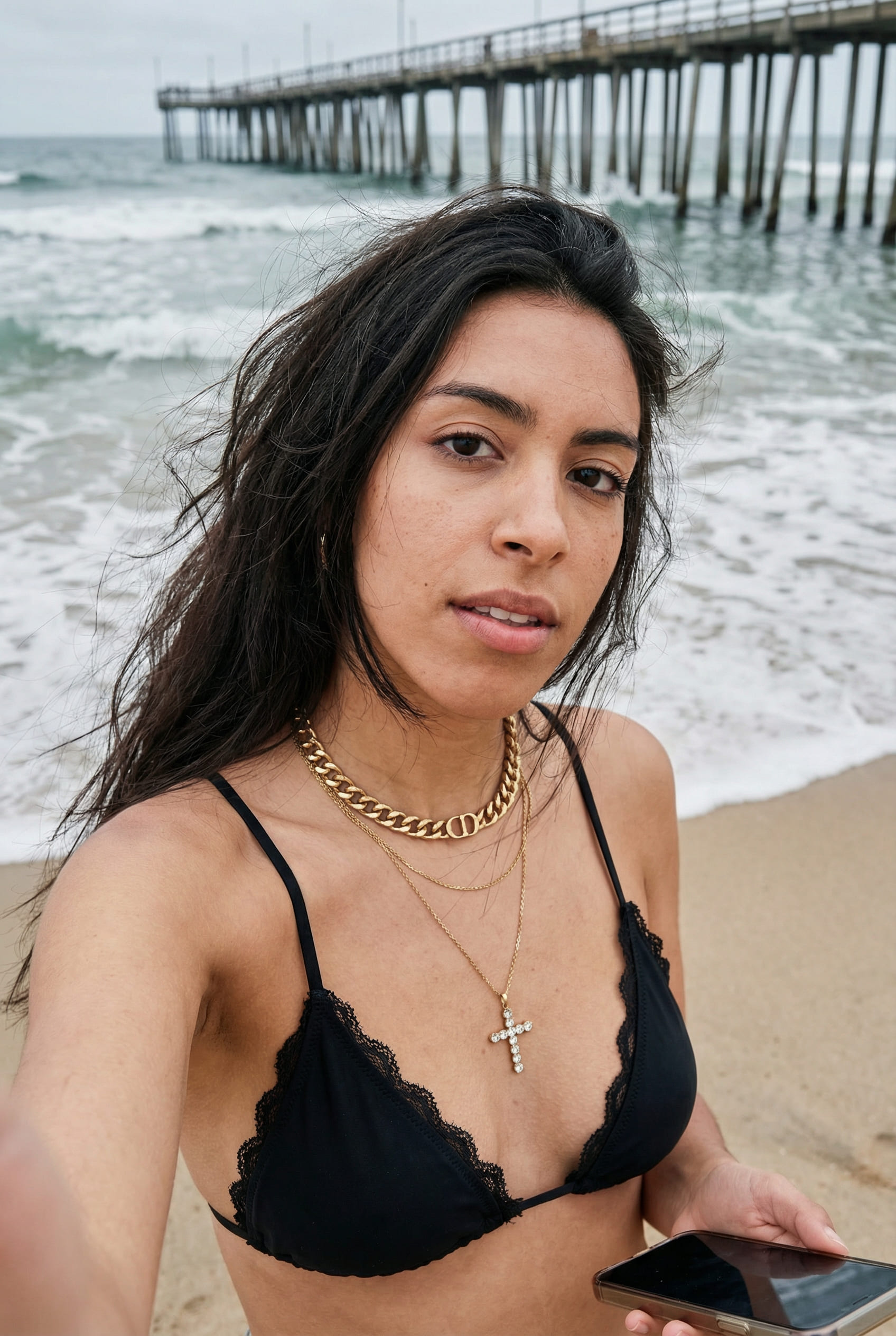 Candid smartphone beach selfie with ocean background