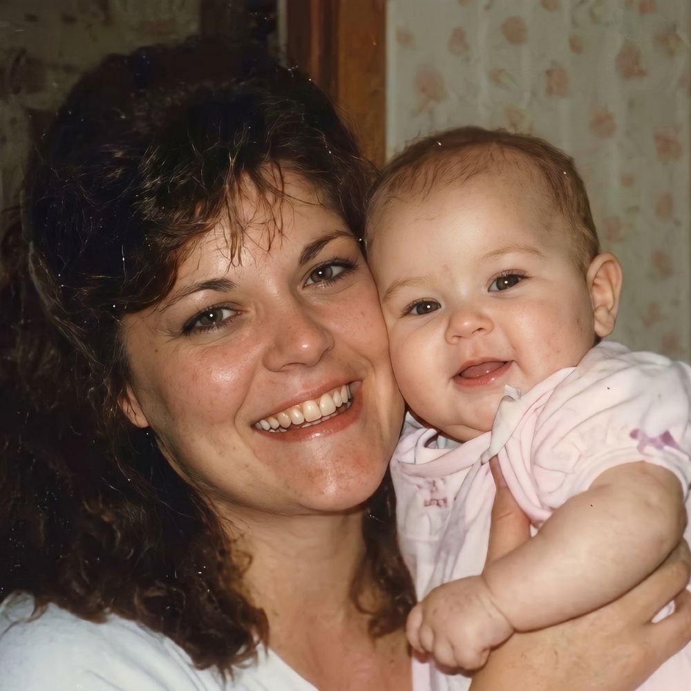 an old photo, fraturing mom holding her baby, turns into 4k after AI restoration