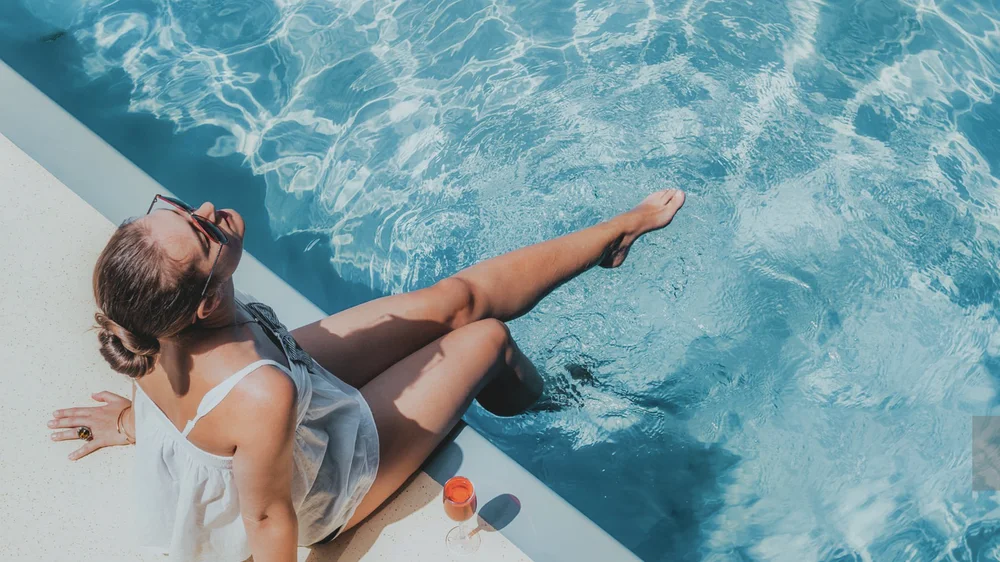 The same photo with a deeper blue pool and warmer skin tones