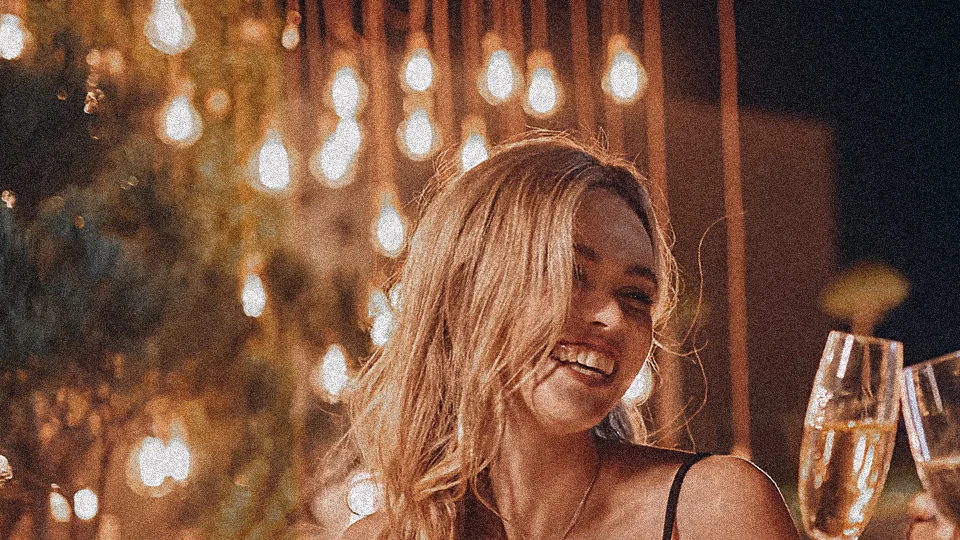 Close-up of the string lights and the blonde woman's face in the original photo