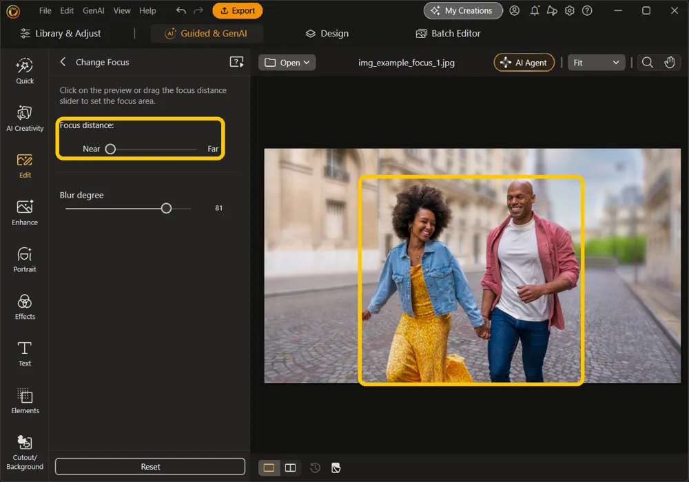 The couple on the canvas and the Focus distance slider at Near highlighted, with the street behind them blurred