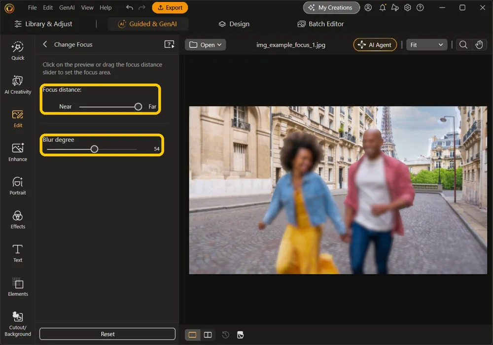The Focus distance slider at Far and Blur degree at 54 highlighted, with the buildings sharp and the couple blurred