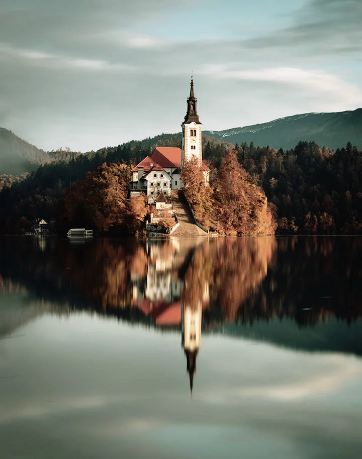 The lake church photo with Landscape HDR Cold 05 applied: muted brown trees and a gray-green sky and water
