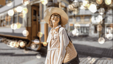 The same bokeh as a looping GIF, with the round lights twinkling and shifting color behind the woman