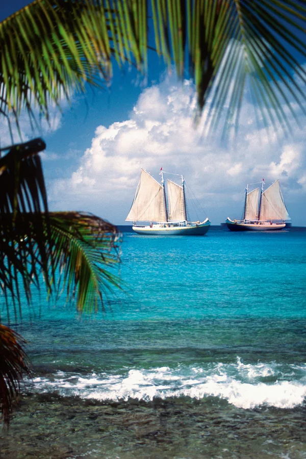 The same photo with a smaller, mirrored copy of the sailboat added to the right of the original