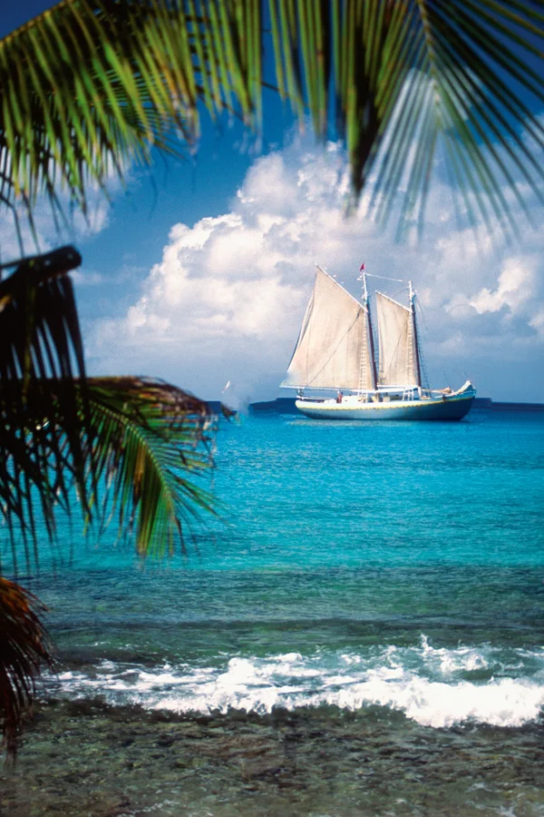 The same photo with the sailboat moved to the right and made slightly larger, its old spot filled with cloud and sea