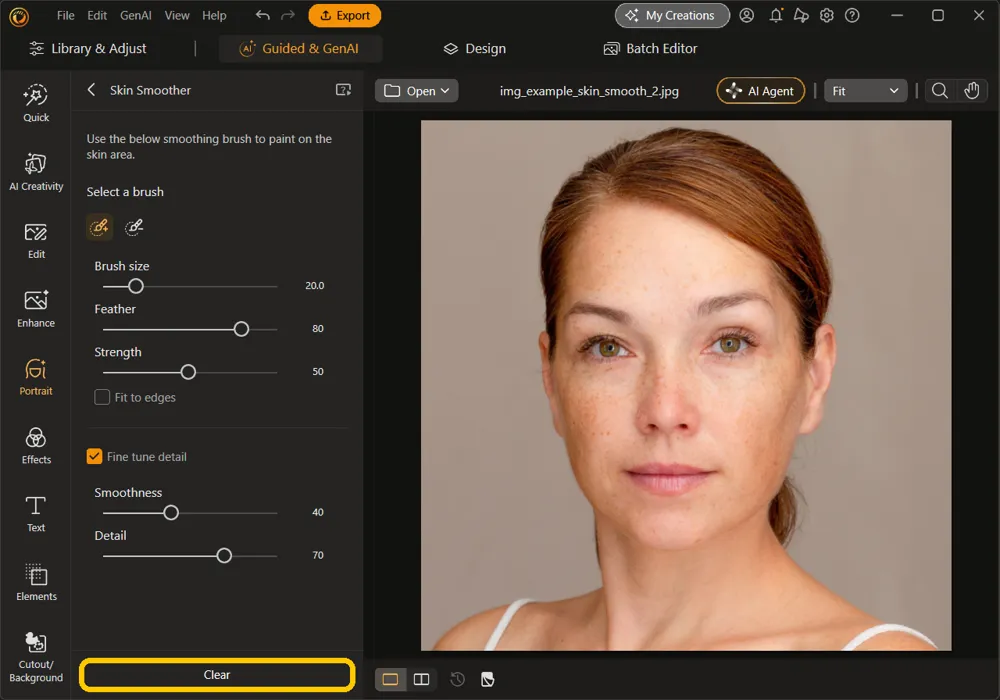 The Clear button highlighted at the bottom of the Skin Smoother panel, with the strokes removed from the portrait and the slider settings unchanged